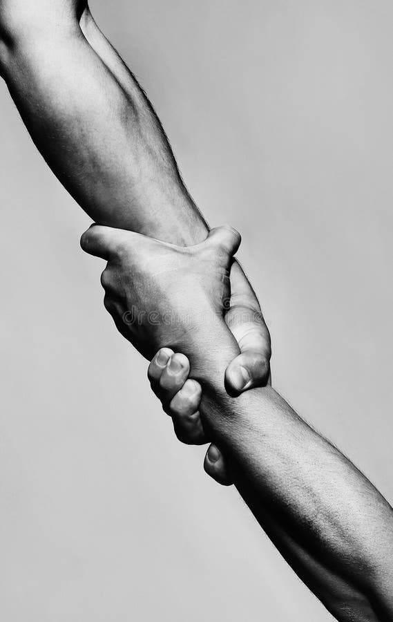 Rescue, helping gesture or hands. Strong hold. Two hands, helping hand of a friend. Handshake, arms, friendship