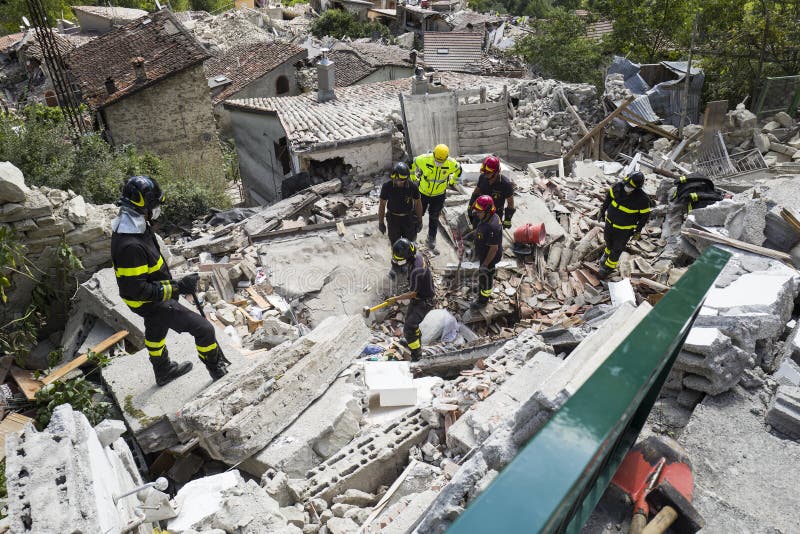 Rescue workers with heavy machinery in rubble of earthquake damage in Pescara del Tronto, Italy. Rescue workers with heavy machinery in rubble of earthquake damage in Pescara del Tronto, Italy.