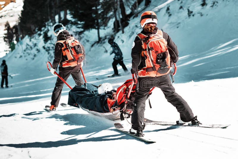 Rescuers at a ski resort evacuate the victim from the slope.
