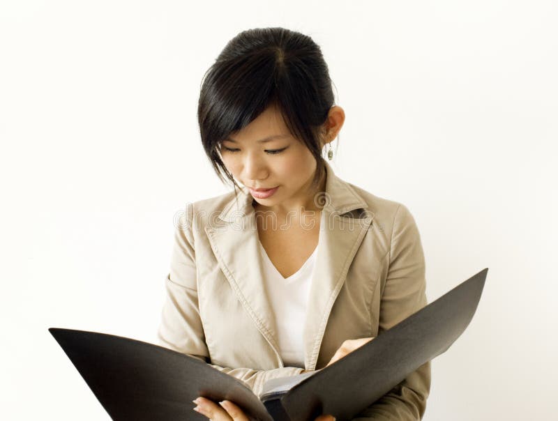 Asian girl reading document. For education/business purpose. Standing file folder stock images, royalty-free photos and pictures