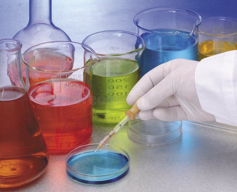 A mano in un laboratorio di ricerca, circondato da fiaschi di pentecoste liquidi colorati.