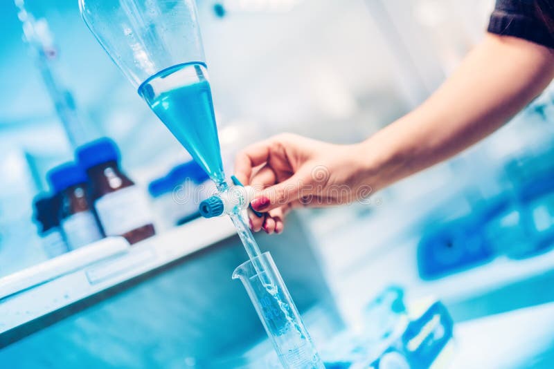 Researching Chemist Engineer Working in Laboratory and Pouring Chemical