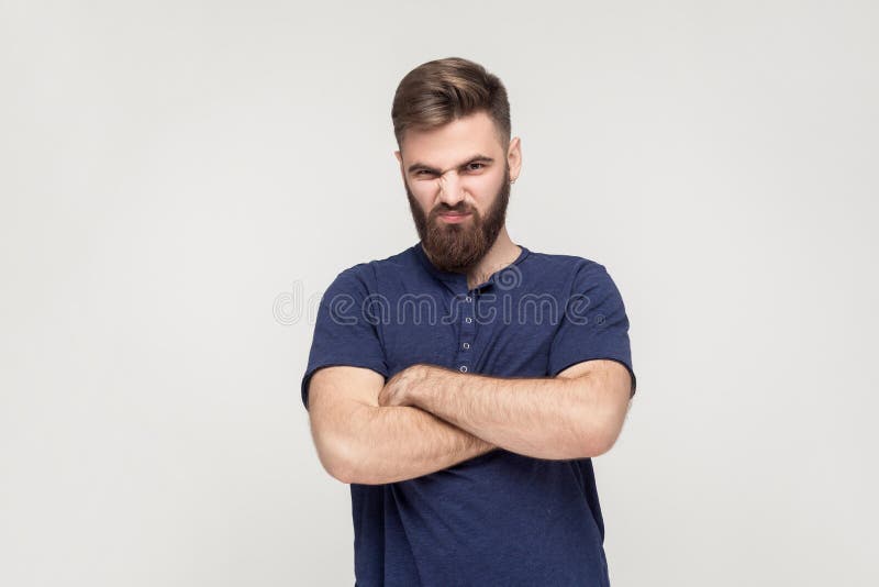 Resentful man, with arms folded, over gray background