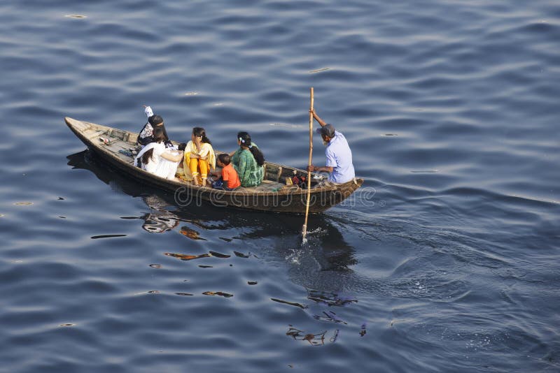 Residents of Dhaka cross Buriganga river by boat in Dhaka, Bangladesh.