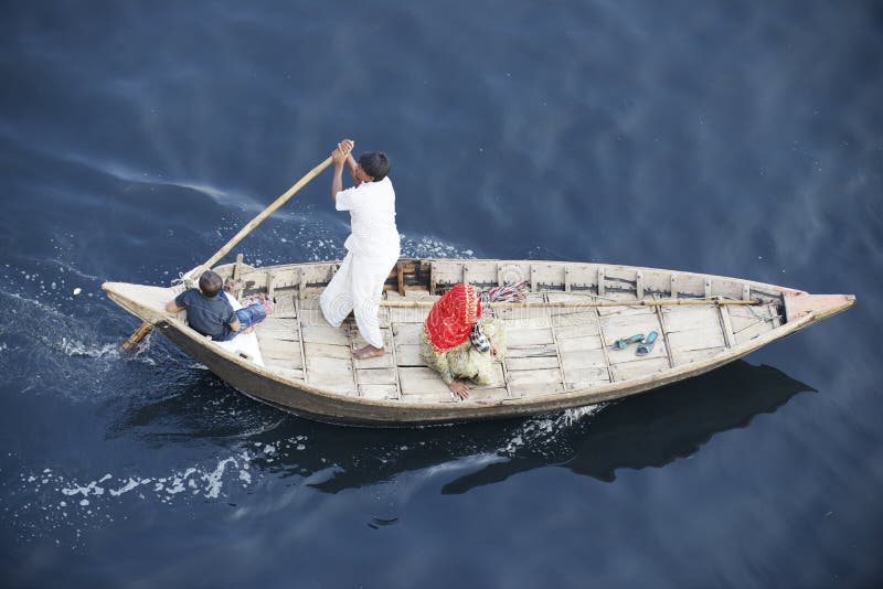 Residents of Dhaka cross Buriganga river by boat in Dhaka, Bangladesh.