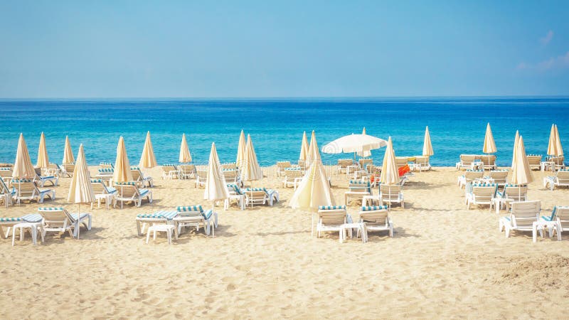 Resort beach with white sand. Tropical summer vacation. Sun beds