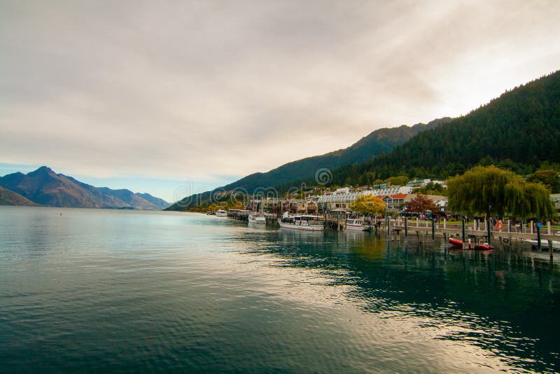 Qeenstown Wharf New Zealand, dock pier on Lake Wakatipu, resort town and Walter Peak royalty free stock photo Qeenstown Wharf New Zealand, dock pier on Lake Wakatipu, resort town and Walter Peak royalty free stock photo