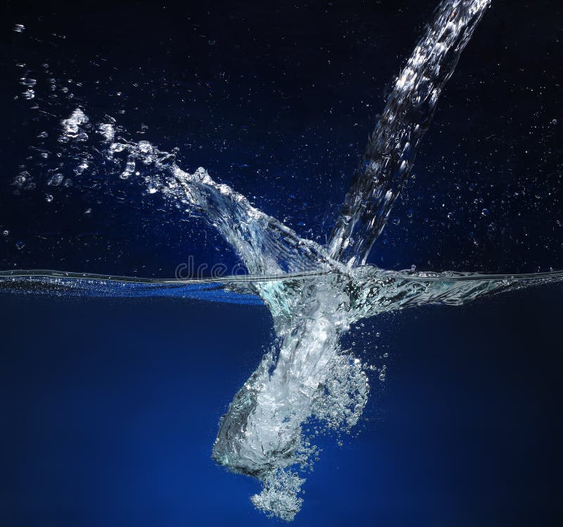 Pouring water Splash image on a blue background. Pouring water Splash image on a blue background