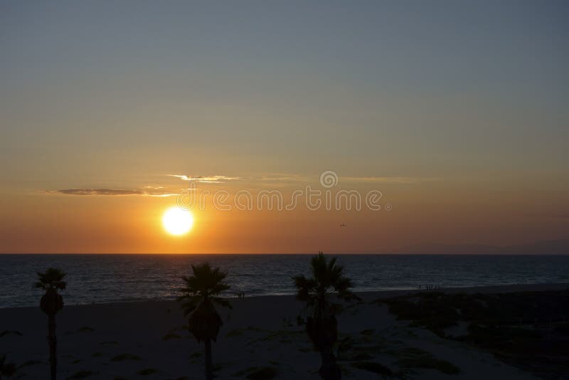 Channel Islands and Mandalay Beach in glowing gold colors of ocean sunset lights, Oxnard, California. Channel Islands and Mandalay Beach in glowing gold colors of ocean sunset lights, Oxnard, California