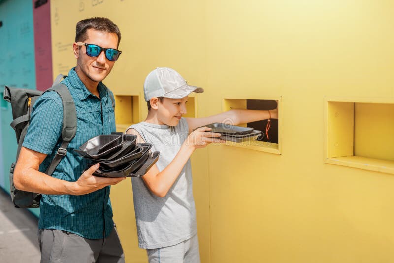 Responsible father educates a young teenager about sorting and recycle of plastic garbage. Green Environmental stock photos