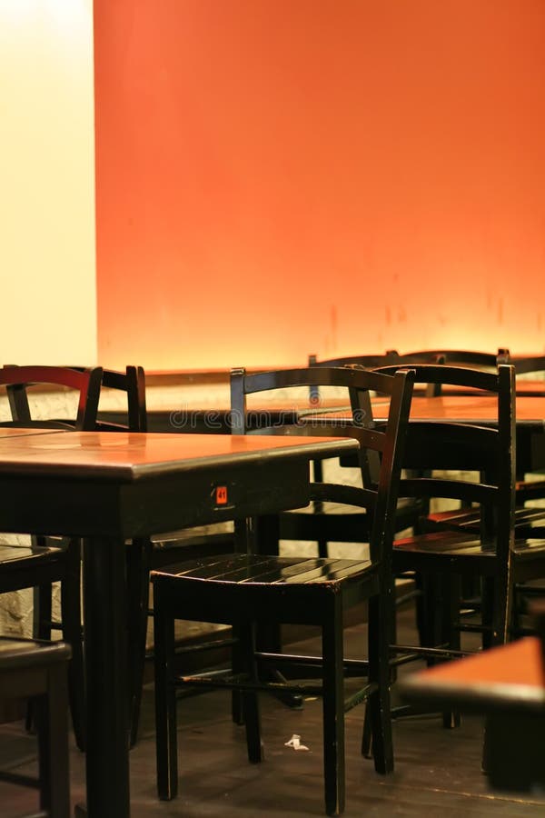 Restaurant orange wall lighting tables and chairs