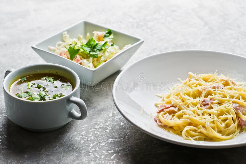 Restaurant business lunch menu, Pasta Carbonara, green salad and chicken soup. royalty free stock image Restaurant business lunch menu, Pasta Carbonara, green salad and chicken soup. royalty free stock image