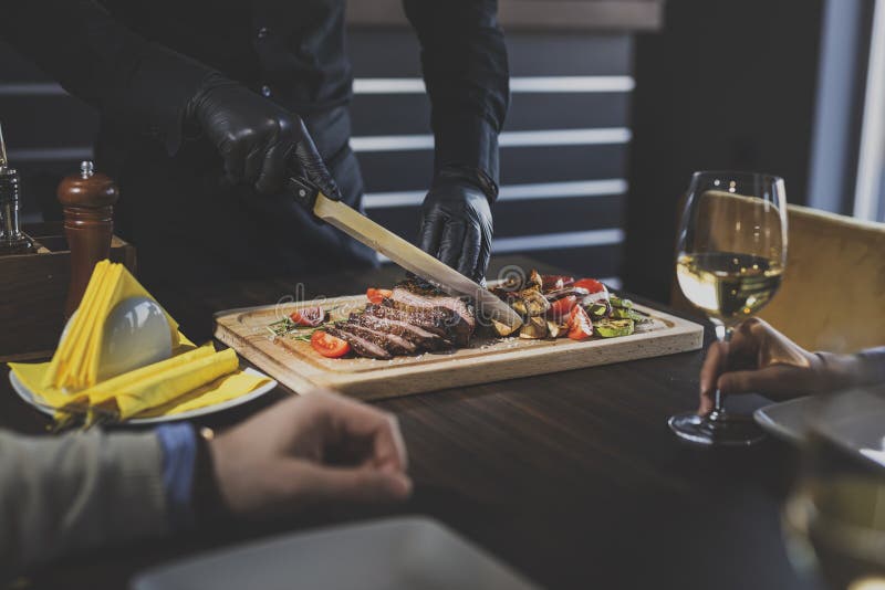 Restaurant chef slicing steak royalty free stock photo Restaurant chef slicing steak royalty free stock photo