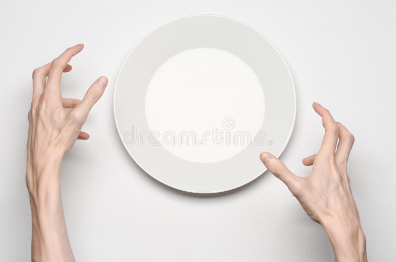 Restaurant and Food theme: the human hand show gesture on an empty white plate on a white background in studio isolated top view