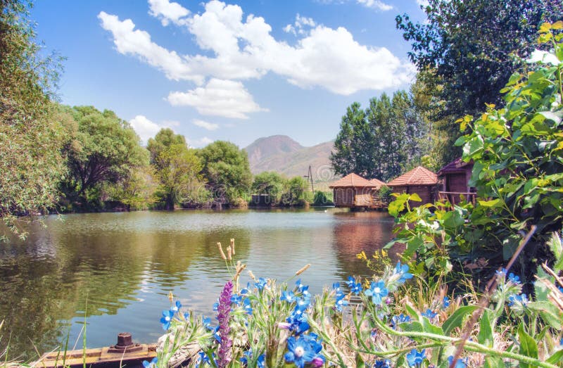 Restaurant Lchak, Yeghegnadzor, Armenia. View of a pond, gazebos and mountains.