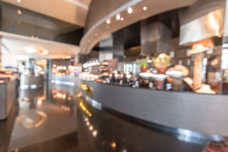 Restaurant open kitchen blur background in luxury hotel showing chef cooking over blurry food counter for buffet catering service