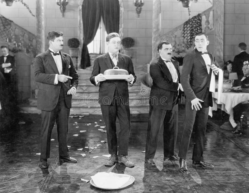 Restaurant with two managers and two waiters and broken plates (All persons depicted are no longer living and no estate exists. Supplier grants that there will be no model release issues.)