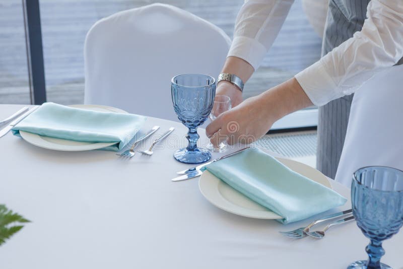 Restaurant waiter serves a table for a wedding celebration stock image Restaurant waiter serves a table for a wedding celebration stock image