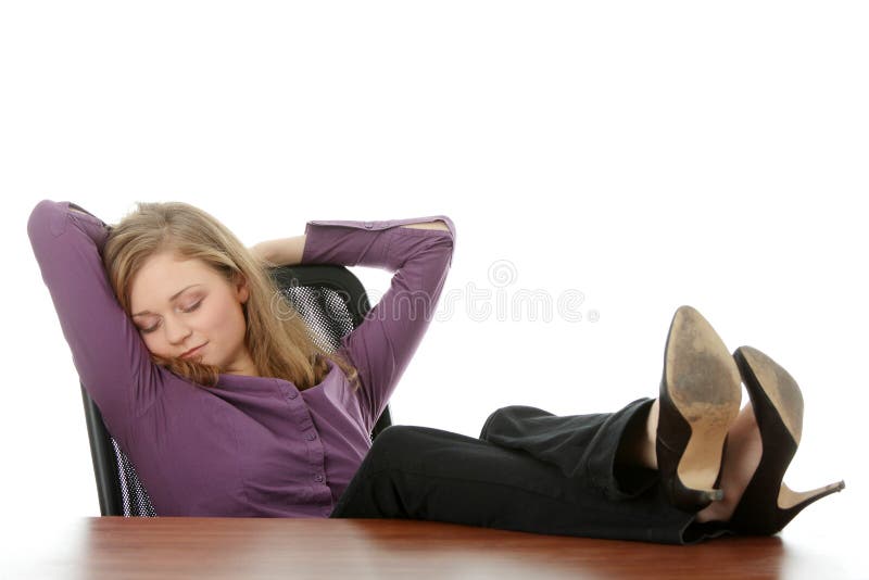 Young beautiful business lady having a rest at the working place. Isolated. Young beautiful business lady having a rest at the working place. Isolated.