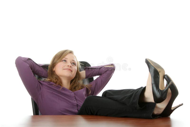 Young beautiful business lady having a rest at the working place. Isolated. Young beautiful business lady having a rest at the working place. Isolated.