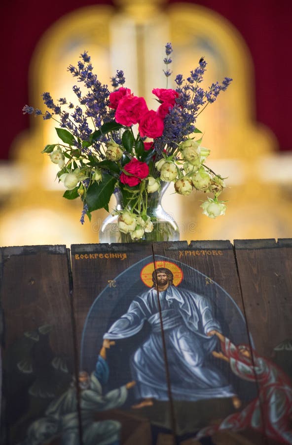 Resurrection of Christ Icon and a beautiful bouquet of flowers in a vase in a church