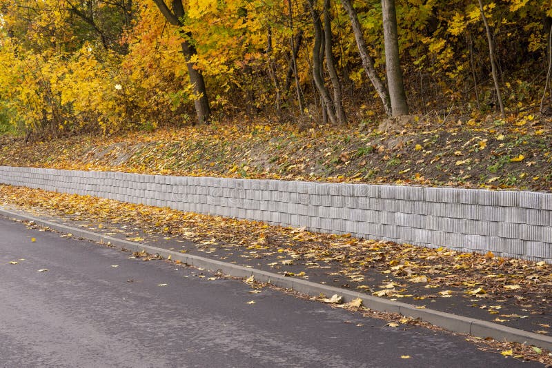 A Retaining Wall Made of Concrete Elements Protects the Roadway and