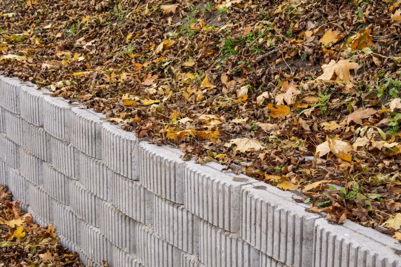 A Retaining Wall Made of Concrete Elements Protects the Roadway and