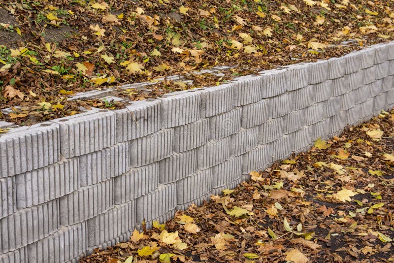A Retaining Wall Made of Concrete Elements Protects the Roadway and