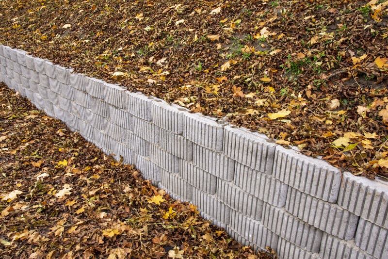 A Retaining Wall Made of Concrete Elements Protects the Roadway and