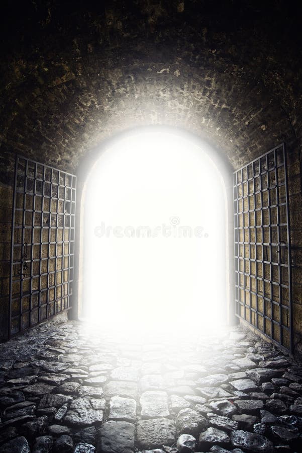 Exit to the light. Light at the end of the tunnel as hope metphor. Old arch gate opening. Exit to the light. Light at the end of the tunnel as hope metphor. Old arch gate opening.