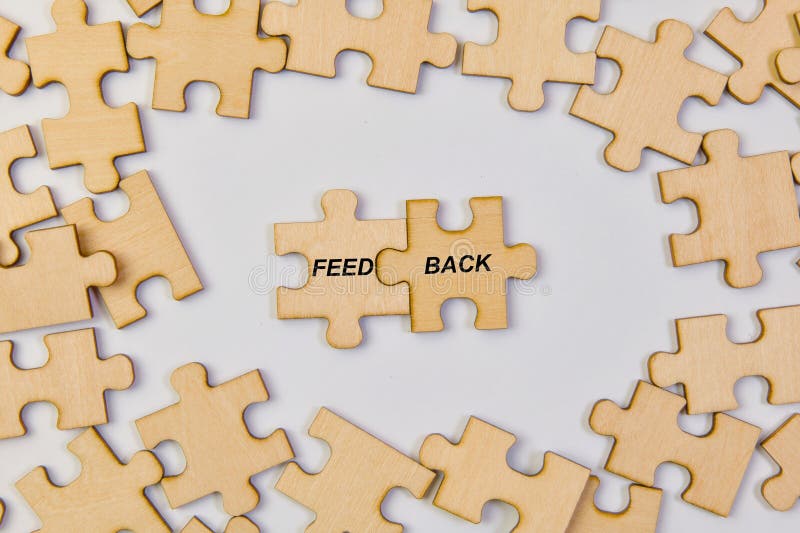 A conceptual photo showcasing the completion of a feedback loop. Interlocking wooden puzzle pieces form the word "FEEDBACK. A conceptual photo showcasing the completion of a feedback loop. Interlocking wooden puzzle pieces form the word "FEEDBACK