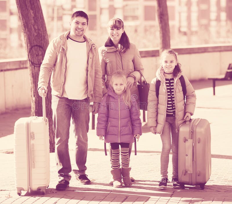 Retrato da família dos viajantes com as embarcações de pesca ao corrico rodadas na mola a Dinamarca imagem de stock Retrato da família dos viajantes com as embarcações de pesca ao corrico rodadas na mola a Dinamarca imagem de stock