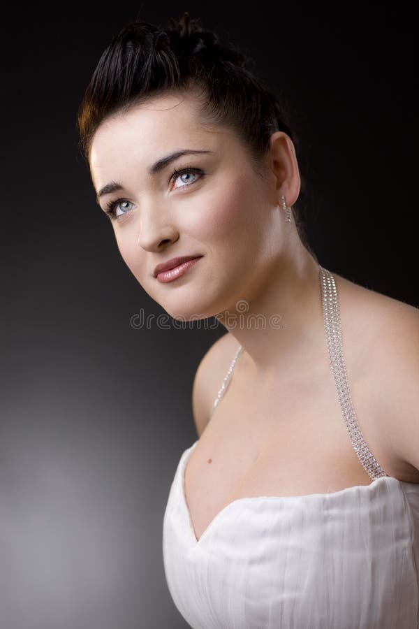 Portrait of a beautiful young bride wearing white wedding dress, smiling. Portrait of a beautiful young bride wearing white wedding dress, smiling.