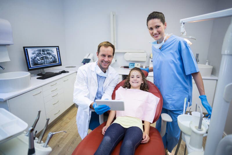 Portrait of smiling dentists and patient in dental clinic. Portrait of smiling dentists and patient in dental clinic