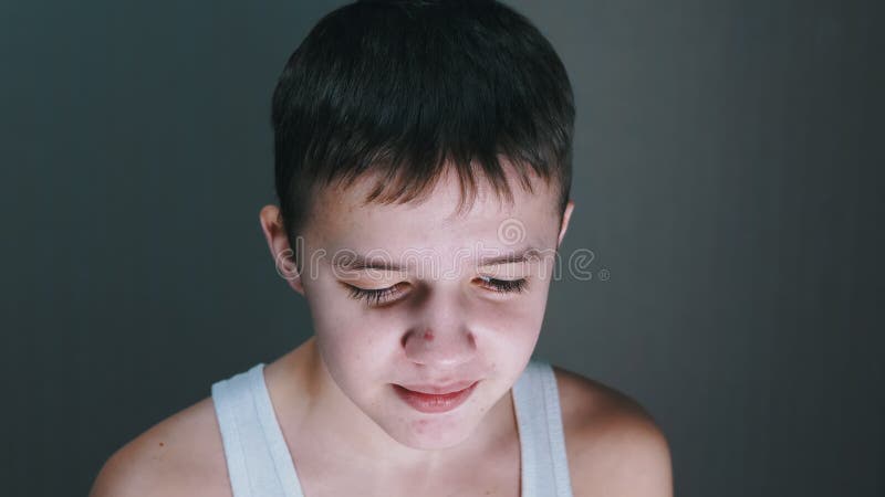 Retrato de la cara de un adolescente que habla mirando hacia abajo. vista frontal. cerrar