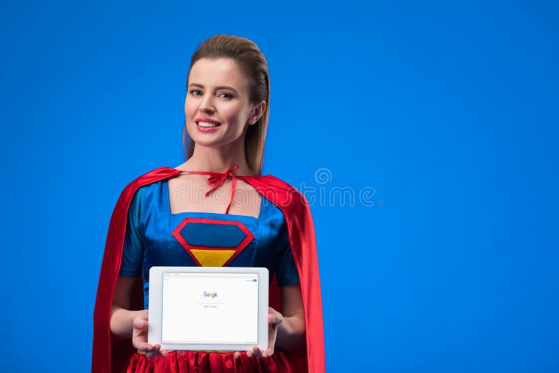 retrato de la mujer alegre en tableta de la demostración del traje del super héroe foto de archivo retrato de la mujer alegre en tableta de la demostración del traje del super héroe foto de archivo