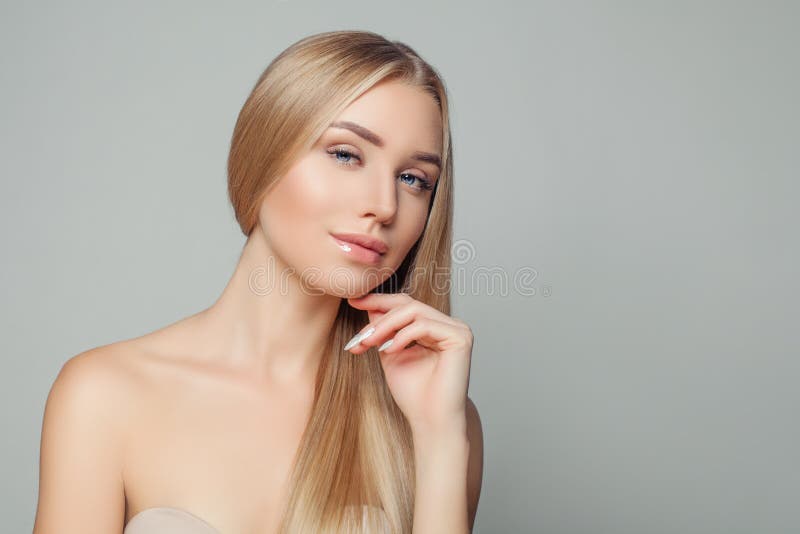 Portrait of pretty young woman with healthy blonde hairstyle and natural clear skin. Beauty girl. Hair and skin care concept. Portrait of pretty young woman with healthy blonde hairstyle and natural clear skin. Beauty girl. Hair and skin care concept.