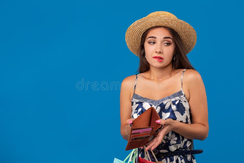 Retrato de la mujer joven infeliz que mira en su cartera en centro comercial, gastado demasiado, no bastante efectivo, dinero per imágenes de archivo libres de regalías Retrato de la mujer joven infeliz que mira en su cartera en centro comercial, gastado demasiado, no bastante efectivo, dinero per imágenes de archivo libres de regalías
