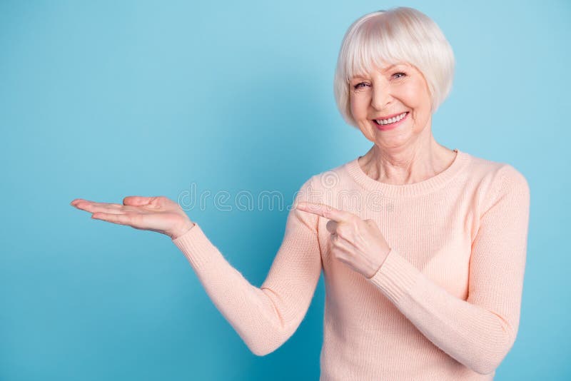 Retrato de la señora preciosa que señala su finger en el promo que lleva el suéter en colores pastel-coloreado aislado sobre fond imágenes de archivo libres de regalías Retrato de la señora preciosa que señala su finger en el promo que lleva el suéter en colores pastel-coloreado aislado sobre fond imágenes de archivo libres de regalías