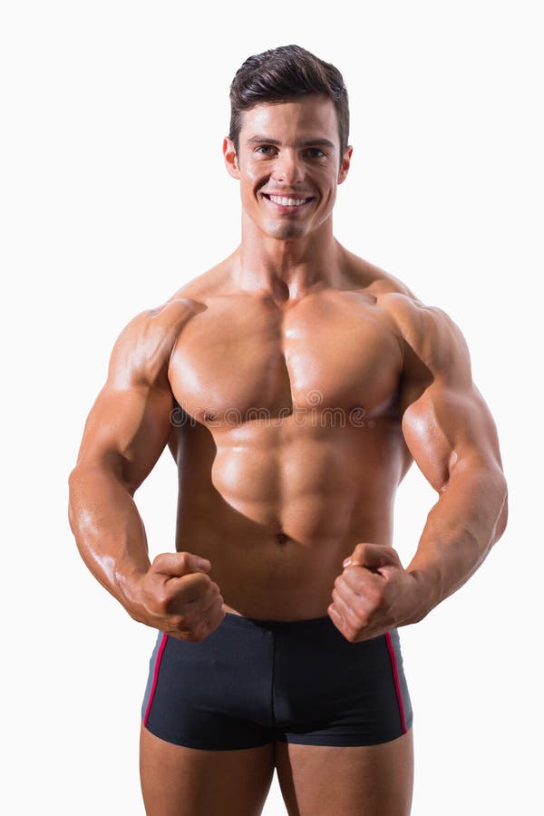Retrato de los puños de un apretón musculares del hombre joven imagen de archivo libre de regalías Retrato de los puños de un apretón musculares del hombre joven imagen de archivo libre de regalías