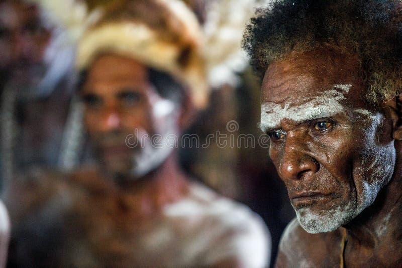 YOUW VILLAGE, ATSY DISTRICT, ASMAT REGION, IRIAN JAYA, NEW GUINEA, INDONESIA - MAY 23, 2016: Portrait of a man from the tribe of Asmat people with ritual face painting on Asmat Welcoming ceremony. YOUW VILLAGE, ATSY DISTRICT, ASMAT REGION, IRIAN JAYA, NEW GUINEA, INDONESIA - MAY 23, 2016: Portrait of a man from the tribe of Asmat people with ritual face painting on Asmat Welcoming ceremony