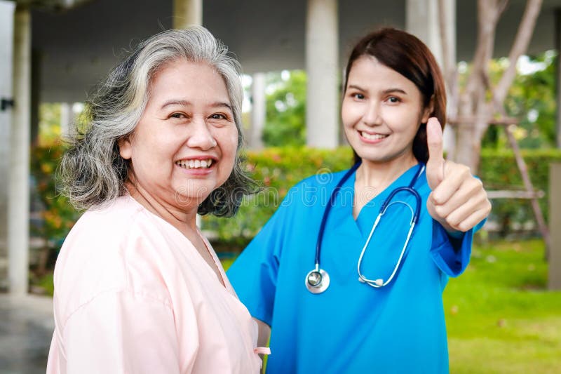 Portrait of an elderly female patient and a surgeon, both smiling brightly, standing outside a building. Medical services in hospitals. health insurance. Portrait of an elderly female patient and a surgeon, both smiling brightly, standing outside a building. Medical services in hospitals. health insurance