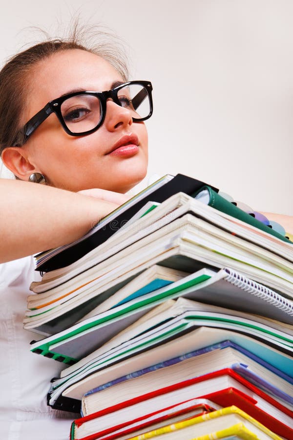 Portrait of a teenage girl and a books heap. Portrait of a teenage girl and a books heap