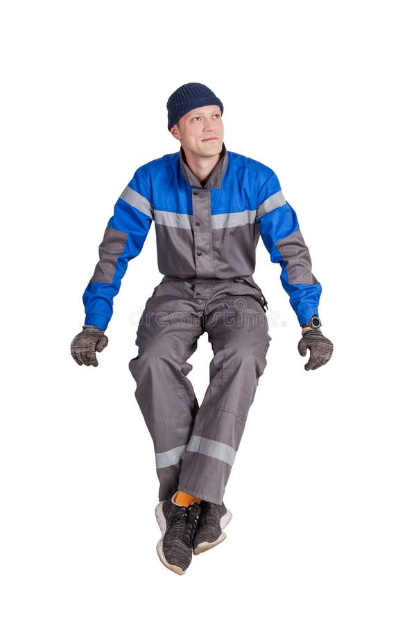 Retrato de un trabajador, de un capataz o de un reparador hermoso de construcción sentándose en un interior blanco imagen de archivo libre de regalías Retrato de un trabajador, de un capataz o de un reparador hermoso de construcción sentándose en un interior blanco imagen de archivo libre de regalías