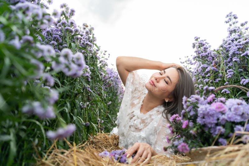 Portrait of beautiful romantic woman in fairy field of Margaret with bouquet. Portrait of beautiful romantic woman in fairy field of Margaret with bouquet.