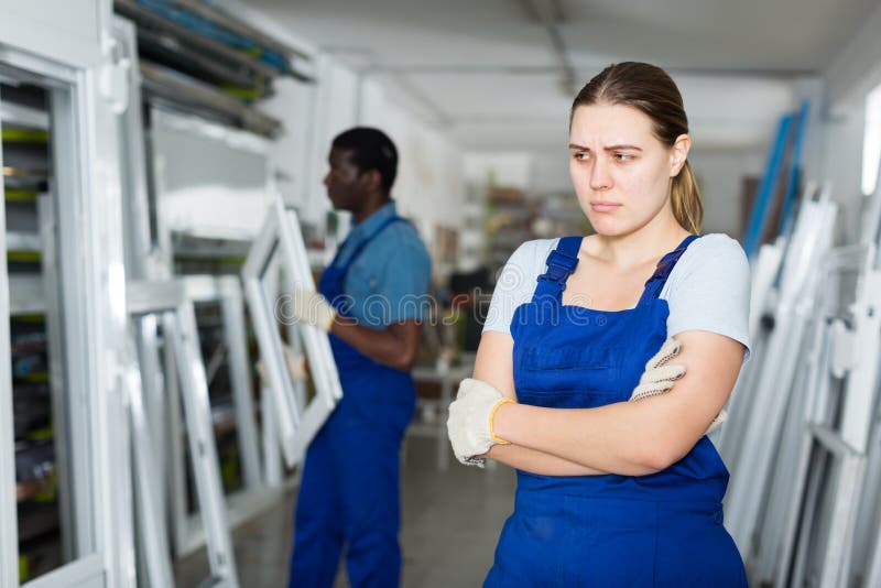 Portrait of female master who is upset in time working on her workplace in the window workshop. Portrait of female master who is upset in time working on her workplace in the window workshop.