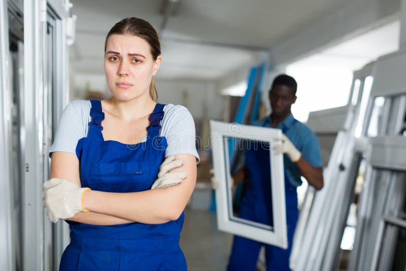 Portrait of female master who is upset in time working on her workplace in the window workshop. Portrait of female master who is upset in time working on her workplace in the window workshop.