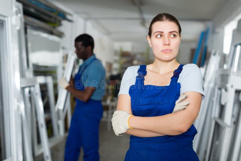 Portrait of female master who is upset in time working on her workplace in the window workshop. Portrait of female master who is upset in time working on her workplace in the window workshop.