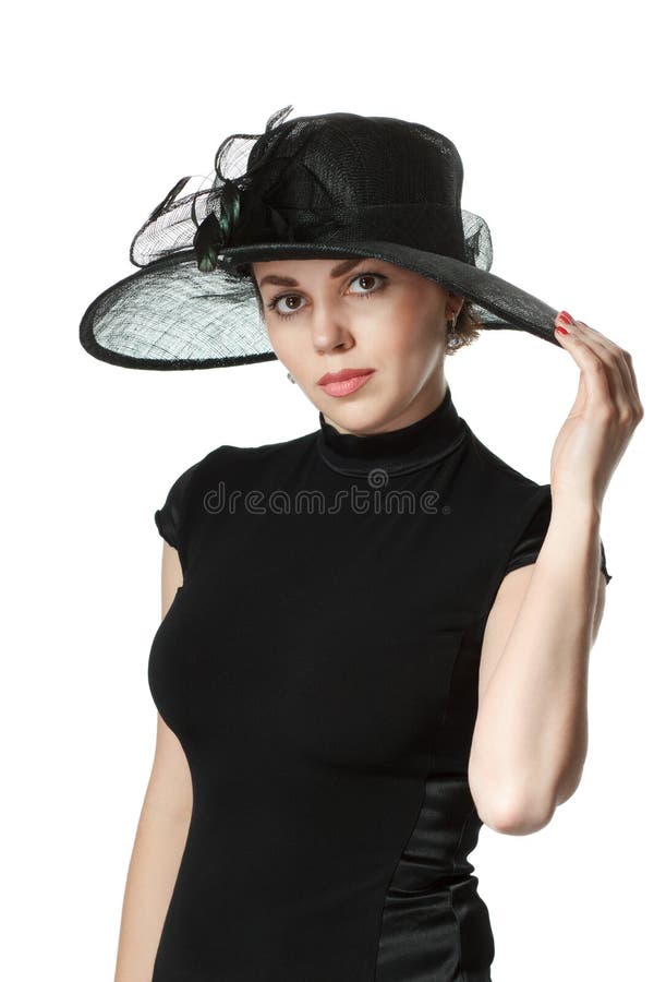 Retrato de una mujer hermosa en un vestido y un sombrero negros aislados imágenes de archivo libres de regalías Retrato de una mujer hermosa en un vestido y un sombrero negros aislados imágenes de archivo libres de regalías