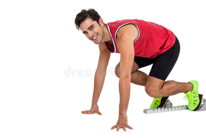 Retrato del atleta de sexo masculino en listo a la posición de funcionamiento imagen de archivo libre de regalías Retrato del atleta de sexo masculino en listo a la posición de funcionamiento imagen de archivo libre de regalías